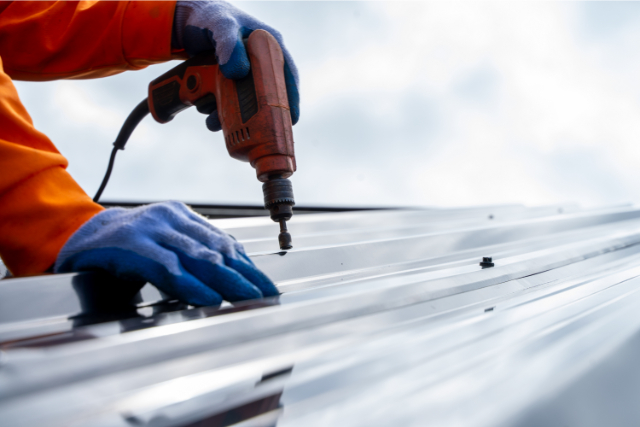 Close-up of a Person Fixing a Roof