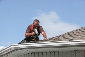 Roof repair by worker